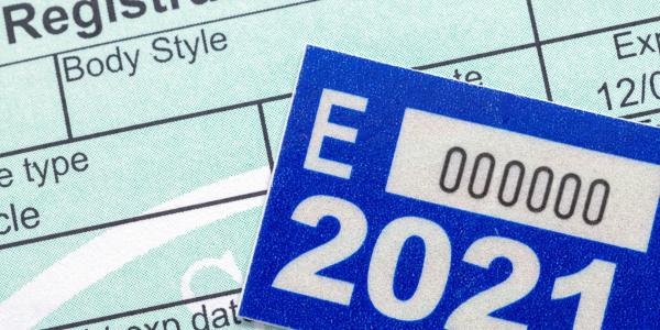 Vehicle registration paper work with sticker tag.